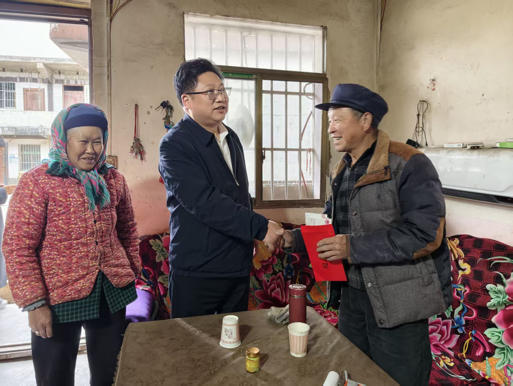 图为周代军慰问残疾人及家属